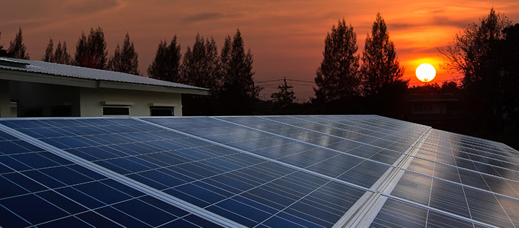 Solar panels soaking up the setting sun's energy during orange skies