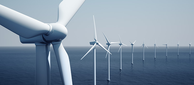 A line of wind turbines in the ocean