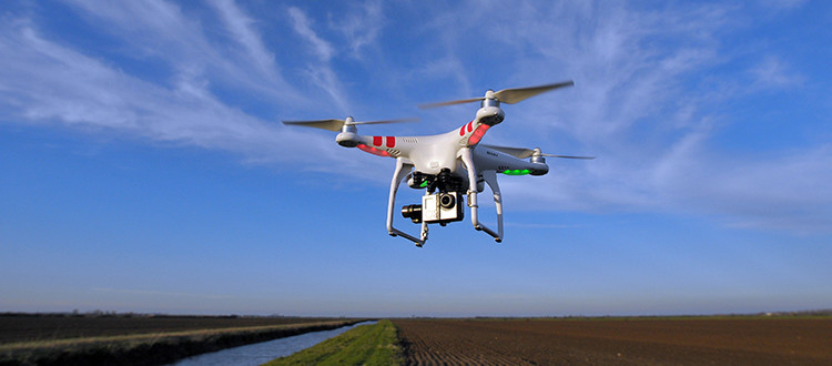 Drone flying around above a field