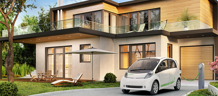 Electric car being charged in front of an eco-friendly built house