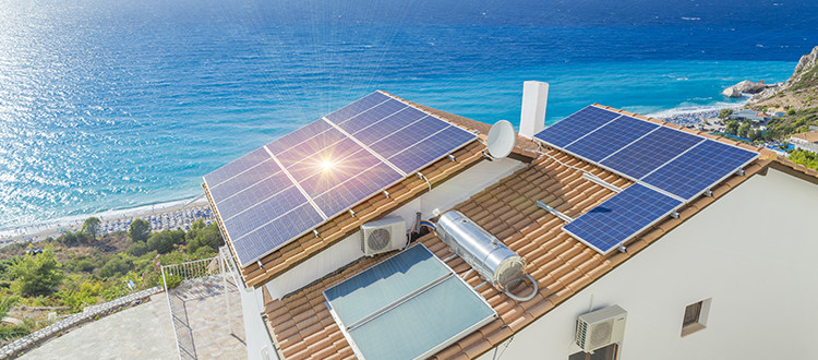 Solar panels on top of a house next to the beach